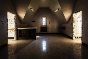 Interior of a detention facility with two open doors and a central counter area.