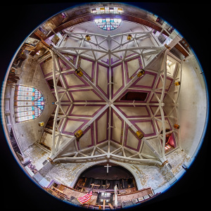 A grand ceiling adorned with intricate beams and vibrant stained glass, echoing celestial designs.