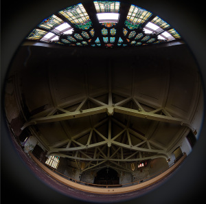 Interior view showcasing a stained glass ceiling and intricate architectural details.