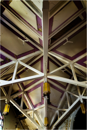 Intricate ceiling beams with a worn, vintage vibe; hints of purple hues