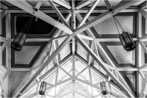 Ceiling with geometric patterns and hanging light fixtures in black and white