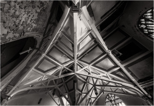 Intricate wooden beams and vaulted ceiling create a striking geometric pattern.