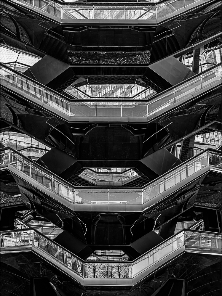 A geometric structure with multiple hexagonal levels and staircases, showcasing intricate design.