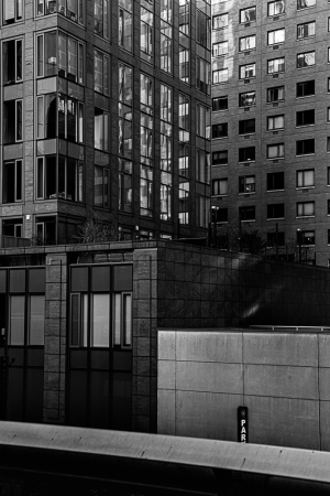 Urban architecture with reflective surfaces and contrasting textures.