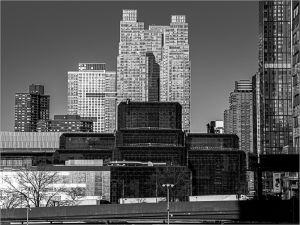 City skyline featuring modern buildings with geometric shapes and contrasting textures.