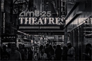 Crowd in front of AMC 25 Theatres in Times Square, New York City at night.