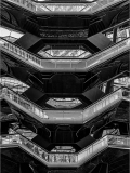 A geometric structure with multiple hexagonal levels and staircases, showcasing intricate design.