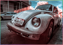 A vintage Volkswagen Beetle parked on a city street, captured in infrared.