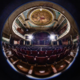 Interior of the Orpheum Theater, showcasing ornate ceiling and empty red seats.