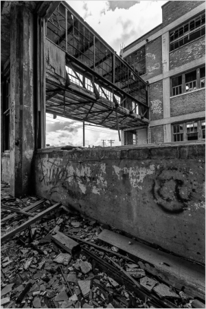 A decaying industrial space with crumbling walls and scattered debris.
