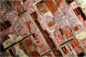 Exposed brickwork revealing layers of historical infrastructure beneath the surface.