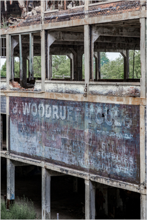 Faded sign on a weathered building, showcasing the name Woodruff & Co.