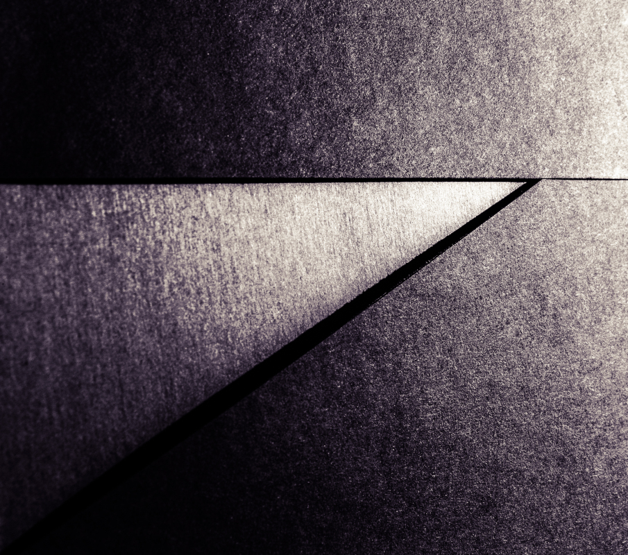 Geometric interplay of light and shadow on textured surfaces.