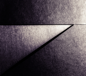Geometric interplay of light and shadow on textured surfaces.