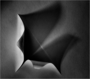 Abstract architectural form with sharp angles and smooth surfaces in monochrome.