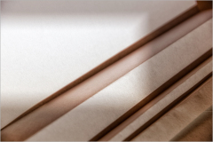Close-up of layered materials showcasing texture and depth in neutral tones.