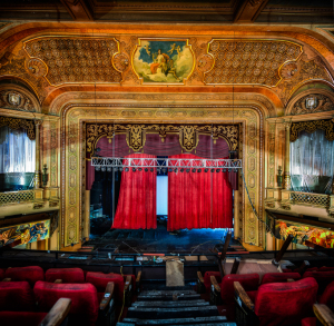 Interior of the Paramount Theatre, showcasing faded grandeur and empty seats.