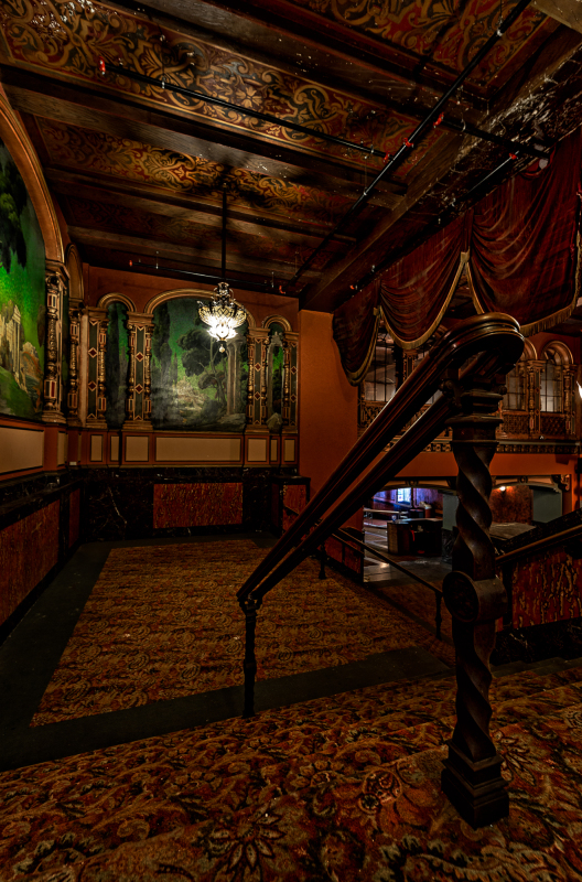 Interior of the Paramount Theatre, showcasing ornate details and a sense of abandonment.