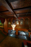 A grand chandelier hangs in the ornate foyer of the Paramount Theatre, casting soft light on the polished floor.