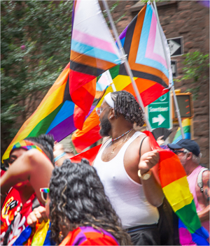 This dude is just engulfed in a rainbow of pride flags!