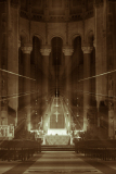 A grand cathedral interior with dramatic lighting and shadows.
