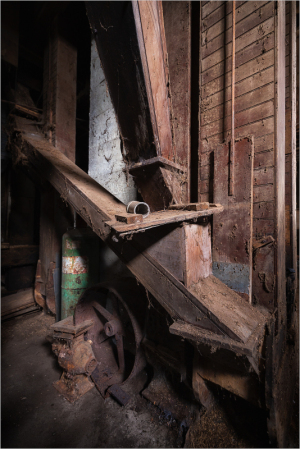 Detailed view of an old wooden structure with machinery and exposed wood.