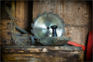 Circular saw blade and hand plane on a wooden surface.
