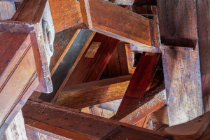 Intricate wooden beams create a geometric pattern overhead, showcasing craftsmanship.