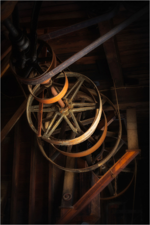 Close-up of vintage mill machinery with wooden and metal components.