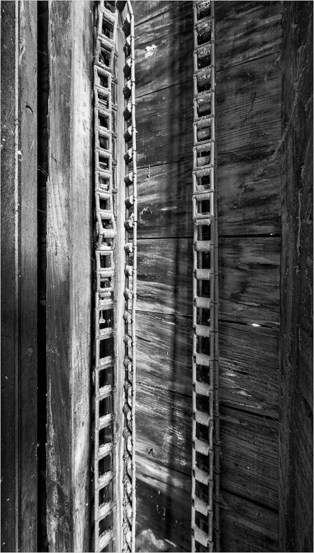 Close-up of wooden beams with intricate patterns and shadows.