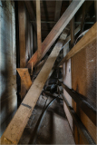 Wooden beams and supports create a complex framework in an industrial setting.