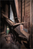 Detailed view of an old wooden structure with machinery and exposed wood.