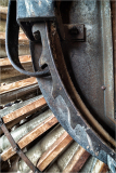Close-up of a weathered watermill wheel with rust and wooden slats
