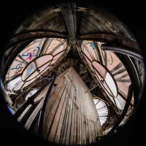 A gritty, abandoned space with warped wood and haunting remnants of graffiti.
