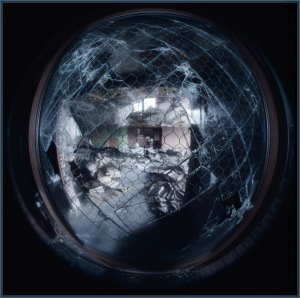 A dimly lit room draped in shadows and cobwebs, peeling textures abound.