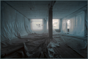 An ethereal space shrouded in translucent plastic sheeting, revealing muted light.