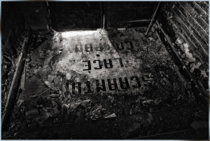 Historic Scranton Lace Factory floor with faded text, revealing industrial past.