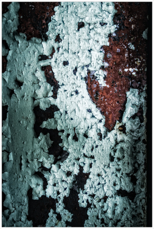 Peeling layers of paint reveal the passage of time on a civic infrastructure facade.
