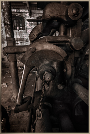 A weathered industrial machine, rusted and forgotten, whispers secrets of a bygone era.