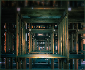 A series of wooden beams create a repeating pattern that draws the eye deeper into the structure.