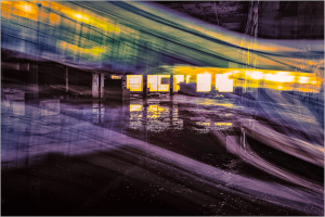 A vibrant display of light and color in an abandoned industrial space.