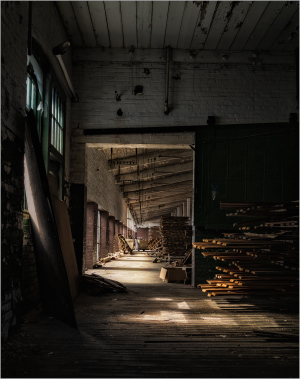 Interior corridor of Scranton Lace Building, featuring wood stacks and natural light