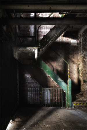 Interior of the Scranton Lace Building with exposed stairwell and brick walls.