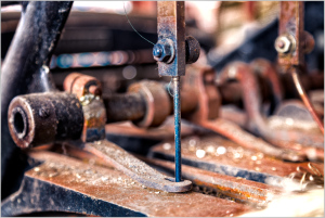 Close-up of intricate machinery revealing rust and texture, gears whisper forgotten tales.