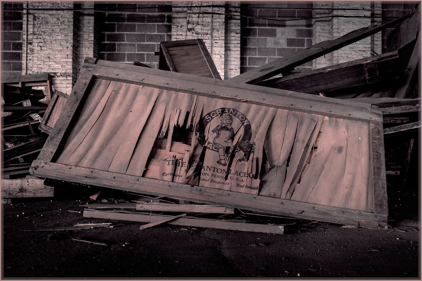 An abandoned frame cradling distorted reflections amidst scattered debris.
