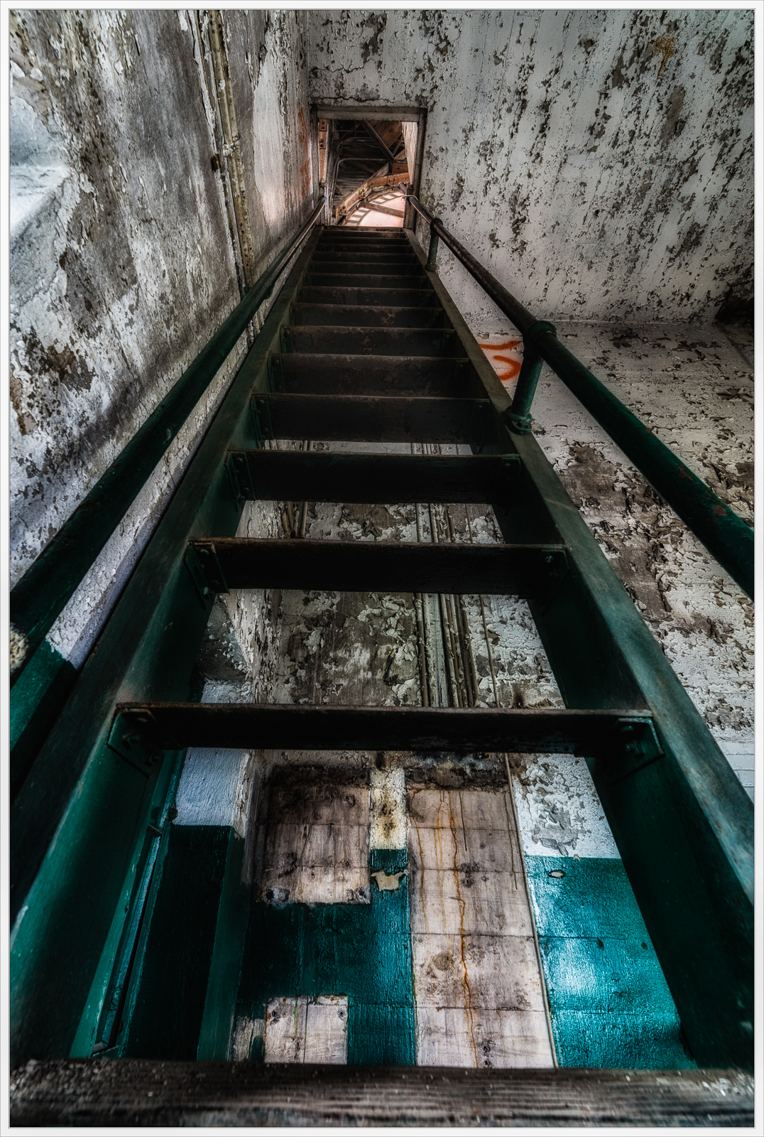 A weathered staircase stretching upward, raw and inviting; echoes of the past linger.
