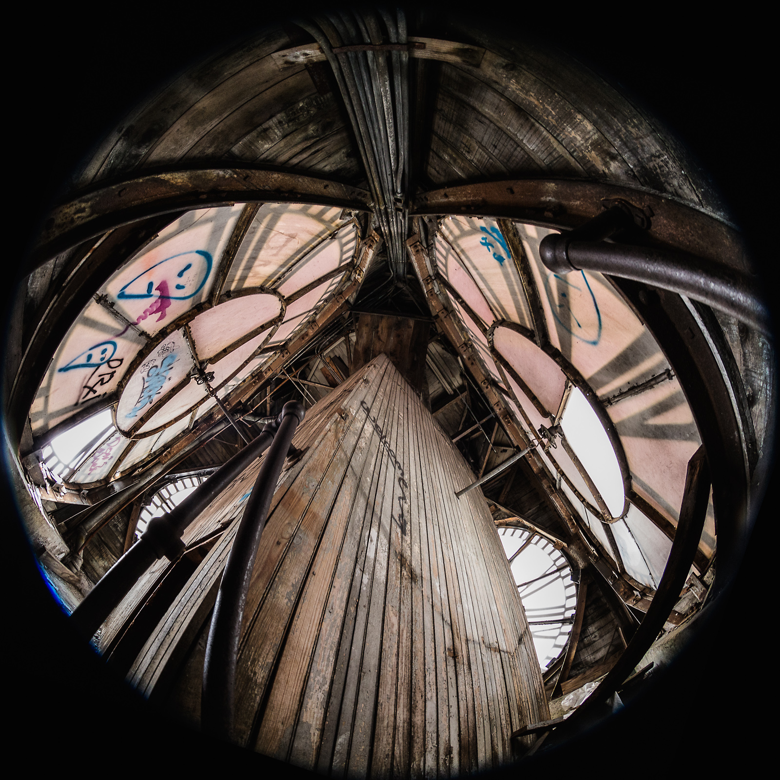 A gritty, abandoned space with warped wood and haunting remnants of graffiti.