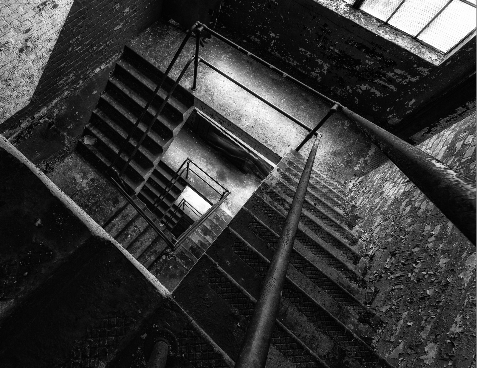 A foreboding descent into shadowy depths, metal and stone entwined.