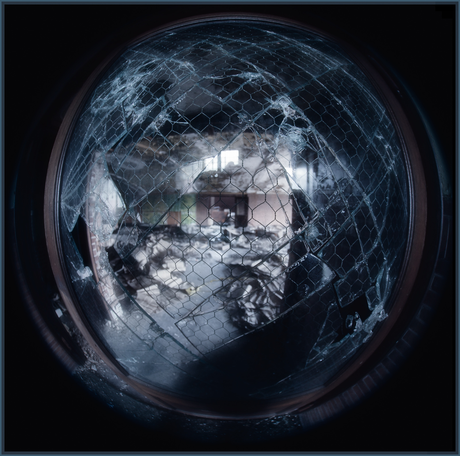 A dimly lit room draped in shadows and cobwebs, peeling textures abound.