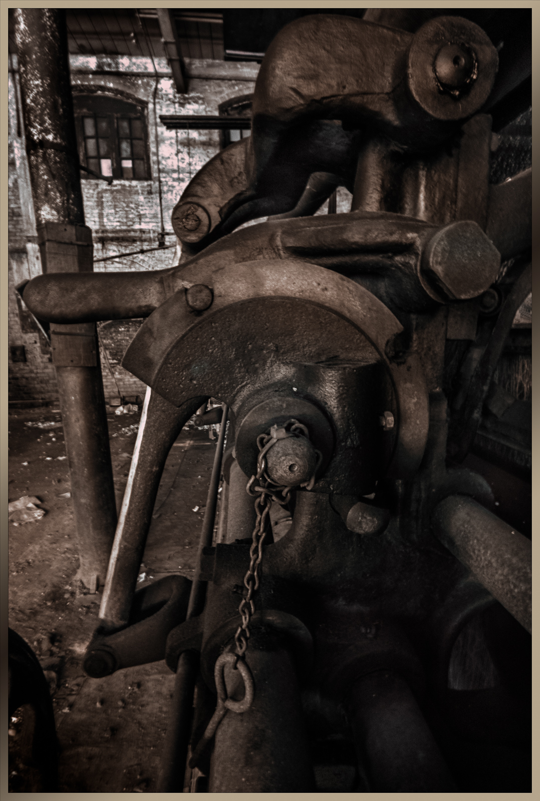 A weathered industrial machine, rusted and forgotten, whispers secrets of a bygone era.